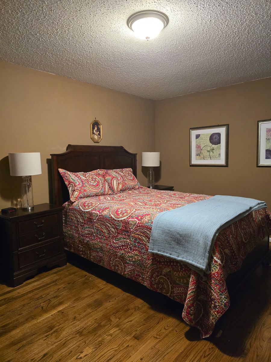 Queen sized bedroom set is in excellent condition and includes bed, side tables, dresser with mirror, and chest of drawers.