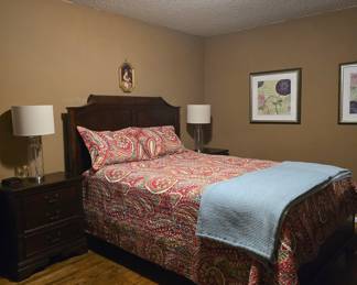 Queen sized bedroom set is in excellent condition and includes bed, side tables, dresser with mirror, and chest of drawers.