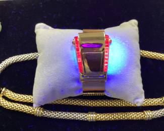 14K BUCKLE BANGLE WITH OVER 3 CTW OF RUBIES 42.2G THIS DESIGNER BUCKLE BANGLE FEATURES 26, 12PT PRINCESS CUT RUBIES AND 2, 15PT CABOCHON RUBIES, ONE ON EACH SIDE. THIS PIECE IS GUARANTEED TO TURN HEADS AT EVERY OCCASION. CARAT WEIGHTS ARE APPROPRIATE.