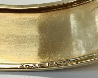 14K BUCKLE BANGLE WITH OVER 3 CTW OF RUBIES 42.2G THIS DESIGNER BUCKLE BANGLE FEATURES 26, 12PT PRINCESS CUT RUBIES AND 2, 15PT CABOCHON RUBIES, ONE ON EACH SIDE. THIS PIECE IS GUARANTEED TO TURN HEADS AT EVERY OCCASION. CARAT WEIGHTS ARE APPROPRIATE.