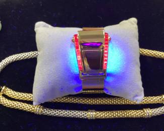 14K BUCKLE BANGLE WITH OVER 3 CTW OF RUBIES 42.2G THIS DESIGNER BUCKLE BANGLE FEATURES 26, 12PT PRINCESS CUT RUBIES AND 2, 15PT CABOCHON RUBIES, ONE ON EACH SIDE. THIS PIECE IS GUARANTEED TO TURN HEADS AT EVERY OCCASION. CARAT WEIGHTS ARE APPROPRIATE.