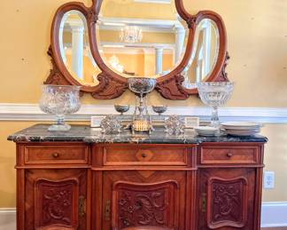 Antique large ornate beveled mirror over an antique marble top ornate buffet