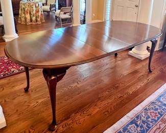Vintage Crescent Oval dining table with 2 leaves and custom made protective pads. 