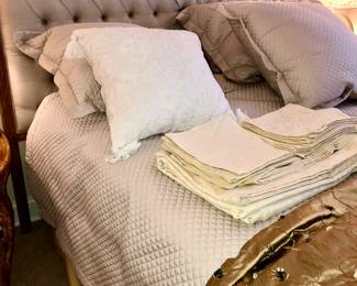 Luxurious bedding and gold drapes