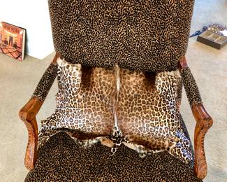 One of a pair of carved leopard arm chairs, pillows are separate