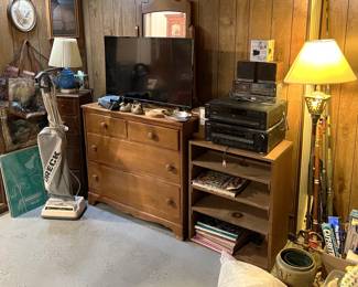You can find a television here, along with more audio/video equipment, a small dresser, another vacuum cleaner, and more.