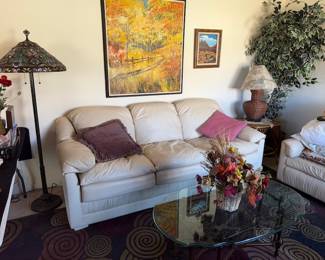 Couch and chair, glass top coffee table lamps, artificial tree, art