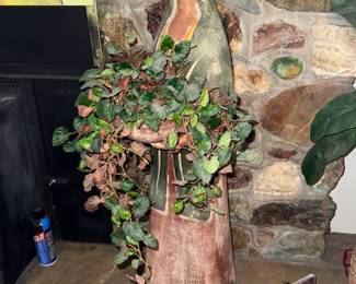 Clay woman with plant