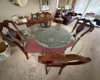 not a very good picture, but a glass top round dining table, with a marble base and 4 chairs