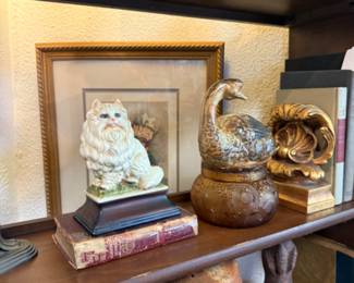 cat figurine, pottery, books