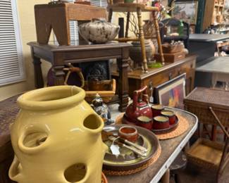 yellow ceramic strawberry pot, end table, chair, figurines