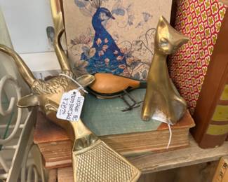 brass cat, vintage brass pieces, books and art