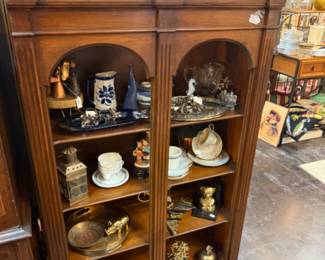 wood bookshelves, tea cup and saucer, pitcher