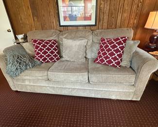 Upholstered sleeper sofa (sold as is - small tear behind center back cushion)
