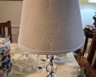 Small modern glam stacked crystal ball table lamp with a beige fabric shade. 