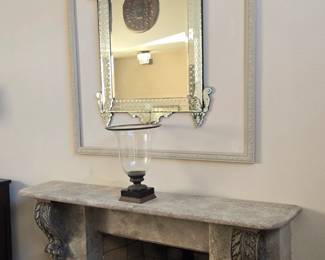Venetian style mirror. Glass/brass/marble urn.  Metal "shield" reflected in mirror.