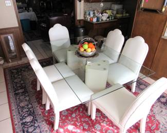 Glass top dining table with 6 high-back vinyl covered chairs