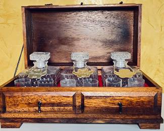 Vintage liquor decanter and shot glass designed in a wooden tantalus chest, for securely to store treasured liquors.