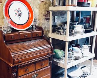 Roll Top Secretary desk next to a shelf with housewares 