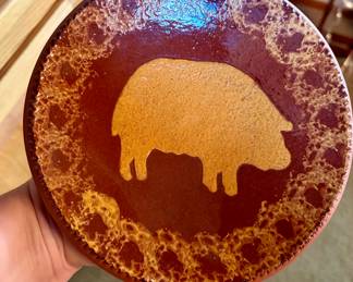 Signed Studio Pottery Pig Plate, 1989
Hand-thrown and hand-decorated studio pottery plate featuring a stylized pig motif. Signed with impressed maker’s mark and dated 1989 on the underside. Rich earth-tone glazes with rustic finish. One-of-a-kind artisan folk art piece
