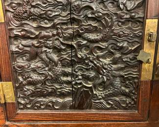 Chinese Carved Hardwood cabinet with Dragon relief panels 20th century, carved dense hardwood possibly Jichimu rosewood . Lower drawer came apart, value $800 OBO
