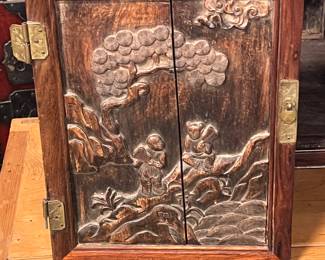Chinese carved hardwood cabinet with high relief figural landscape, early 20th century, value $1500 OBO; 