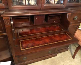 Front of top drawer drops down to reveal pull-put writing surface (desk) with small drawers & cubbies