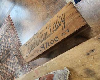Shoe advertising on wooden crate.