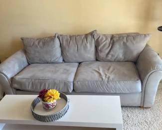 A Sofa, A Table And A Lamp