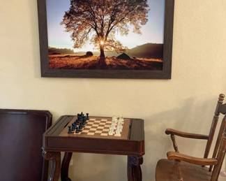 A Reversible Backgammon Checker Table With One Side Chair And A Framed Canvas Print