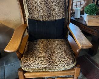 Oak chair with animal print pillows and a black pillow. Will presale this item $250