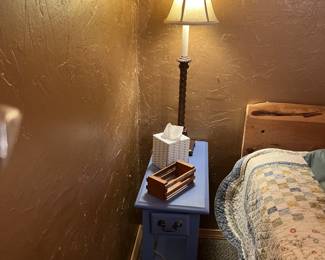 Narrow blue nightstand with tall lamp