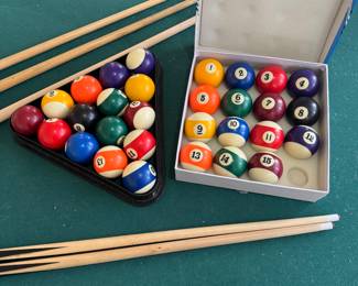 Pool table, cues, and billiard balls