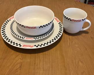 Coca-Cola black checkered plates, bowls, cups.  Several pieces of each.