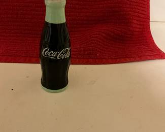 Minature Coca Cola bottle.  About an inch tall