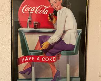 Refreshing!  Young lady having a Coke and a smile.