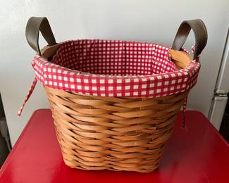 Wicker basket with handles and red checkered cloth
