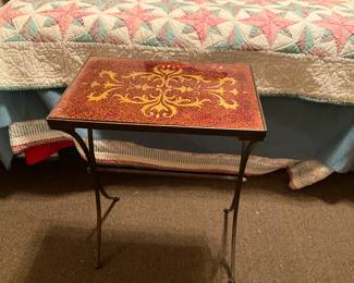 Red colored table with gold colored design