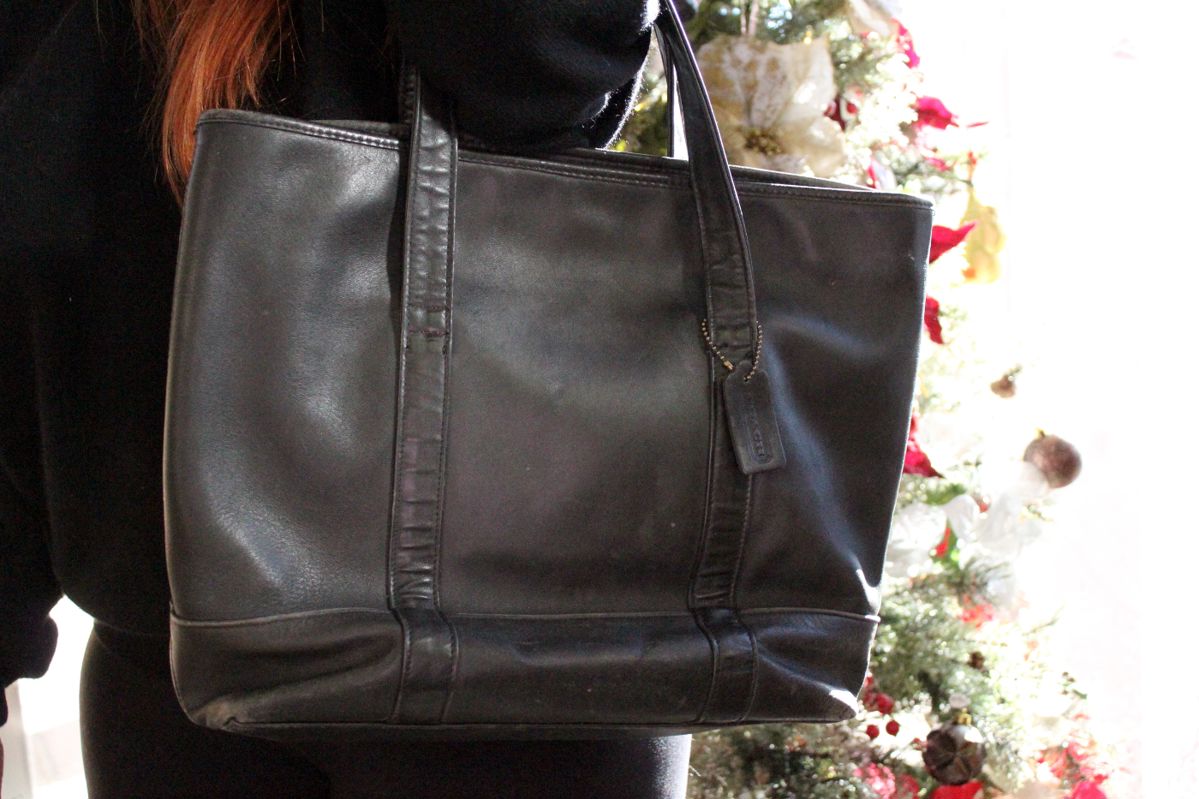 A vintage Coach soft leather tote bag, 15" x 13" x 4", with a 7" strap, shows some very minor ware on outside. This item can be shipped.