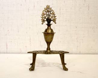 An antique brass Surma Dani, also known as a kohl or eyeliner holder, 7" x 5"
in a lot with, a vintage brass pedestal basket, 7" x 4"
vintage silver-plated shell-shaped serving tray 11.5" x 8" x 1.5" with a cup at 3" x 2"
gold-toned metal display stands or easels, possibly in a Hollywood Regency style from the 1970 at 3" and 4"
These items can be shipped.