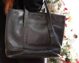 A vintage Coach soft leather tote bag, 15" x 13" x 4", with a 7" strap, shows some very minor ware on outside. This item can be shipped.