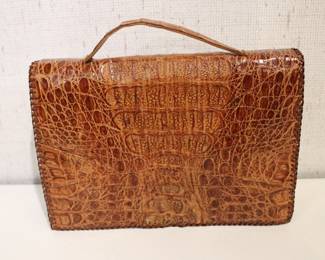 A vintage 1940s - 1960s genuine alligator skin clutch bag 10" x 7" x 2", and a floral leather folding wallet 6" x 3". These items can be shipped