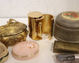 A small woven basket 4.5" x 1.5", a vintage Italian alabaster trinket box 3.25" x 1.25", antique W.B. Mfg (Weidlich Bros) Art Nouveau jewelry casket or trinket box 4" x 3.5" x 3", a vintage Wadsworth Opera Vanity containing a case of vintage Revlon Snow Rose 141 lipstick 4" x 2", a vintage tin trinket or powder box, wind up music that plays when you remove the lid 6" x 4", a vintage brass stamp box 3.25" x 2" x 1", a Merle Norman makeup brush 6", and lastly a a pill cutter and splitter 3.5" x 1". These items can be shipped.