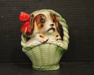 vintage 1950s Norleans Cocker Spaniel Ceramic Green Woven Handled Basket Coin Bank, 6" x 5", in a lot with a vintage Redware French black poodle Bookend Pen Holder 7" x 3" x 2",  Vintage Ceramic Poodle Figurine: Hand-Painted Dog Collectible 6" x 4", hand-painted ceramic fortune cookie-shaped trinket 2" x 1". These items can be shipped.