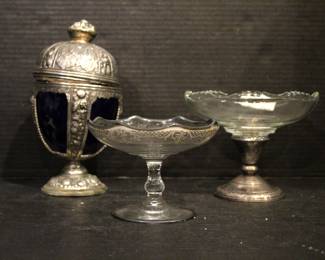 Jennings Brothers (JB) Art Nouveau chalice with a cobalt blue glass insert and lid, 9" x 5"
Frank M. Whiting sterling silver and glass compote bowl,  5" x 6" 
vintage glass compote or candy dish featuring a silver reinforced Art Nouveau style, 4" x 5"
These items can be shipped