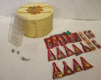 A vintage 1940-1950s Princess brand yellow wicker sewing basket with a floral decal lid including; 6 tweezers with an attached magnifying glass, 5 thread snips or "speeding scissors", 9 vintage embroidery scissors. Along with a plastic dish, 2 thimbles, and a small bag of safety pins. These items can be shipped.