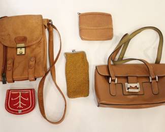 A vintage brown faux leather crossbody or messenger bag with a flap closure, a buckle, a vertical front zipper pocket, and an adjustable strap, 9" x 6" x 3". A red leather south western wallet 3" x 4", a light brown faux leather coin purse 5" x 5", a vintage fabric coin purse 7" x 3". Lastly a Mondani of New York leather purse 9" x 6" x 2". These items can be shipped.