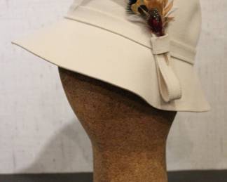vintage Betmar New York wool felt cloche hat in cream with a feather accent, 11" from brim to brim, 7" tall. This item can be shipped.