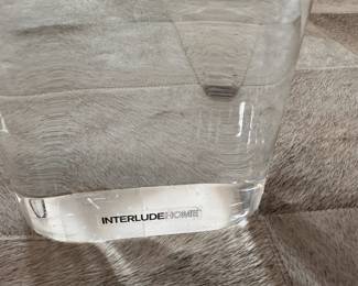 A-MAZE-ING! Interlude Home Glass and Lucite table. You can configure the legs any way you want, the glass simply inserts into the Lucite legs! Even I'm impressed!