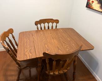 Vintage wood drop leaf dining table with four chairs, other chairs upstairs $75
